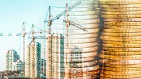 Construction site in the background with fading piles of gold coins in the front