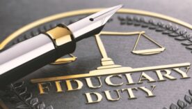 Plaque with words Fiduciary Duty written on it and a very stylish calligraphy pen on top