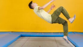Man on a trampoline about to land on his back