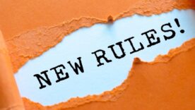Text sign showing the words "New Rules"