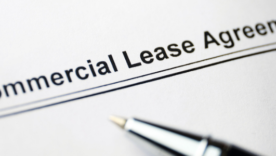 Commercial Lease Agreement document with a pen in the foreground