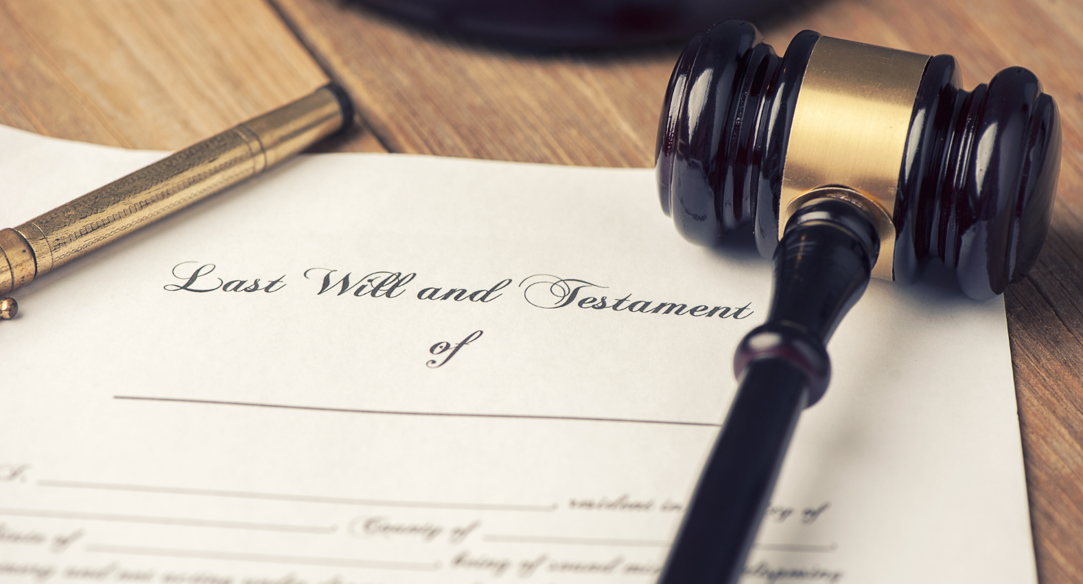 Will and Testament with a legal gavel and a pen on a desk