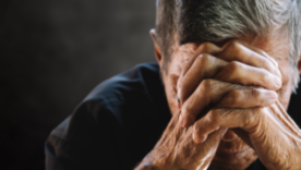 Senior man covering his face with his hands. Depression