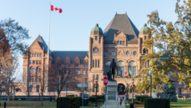 View of Queen's Park Legislative Assembly of Ontario and John A. Macdonald Statue on clear sunny day