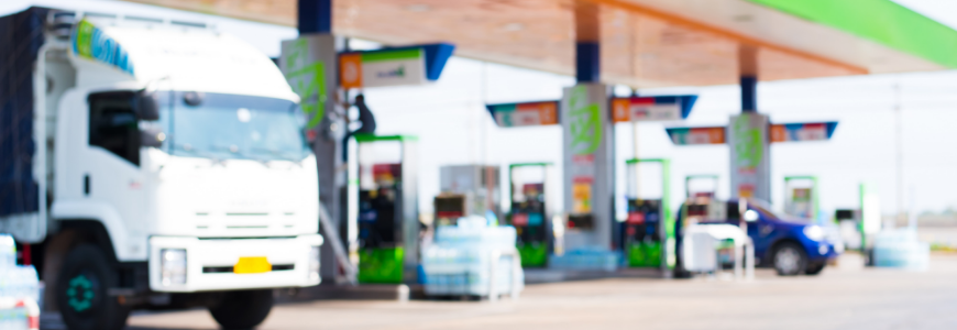 Gas station with a truck and cars blurred into the background