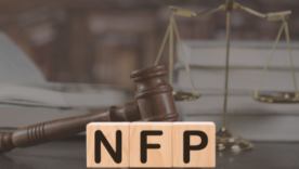 legislation law legal concept. gavel, legal weights and books in background. The letters NFP are in block in main focus