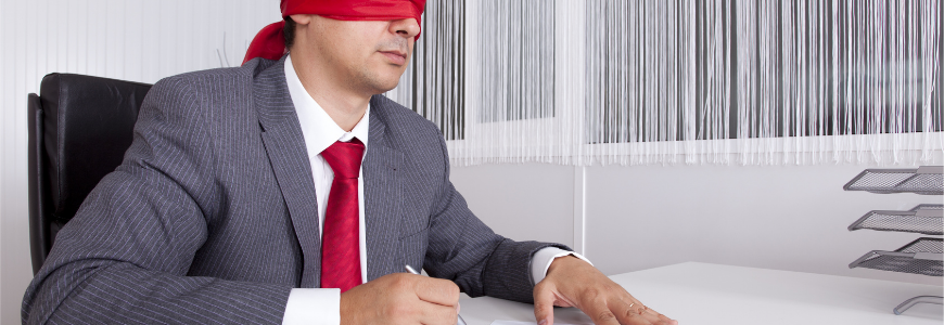 Blindfold businessman at the office working signing a contract
