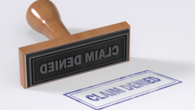 Rubber stamping that says Claim Denied on White Background.