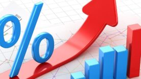Percent symbol and business chart on financial paper, red arrow moving up.