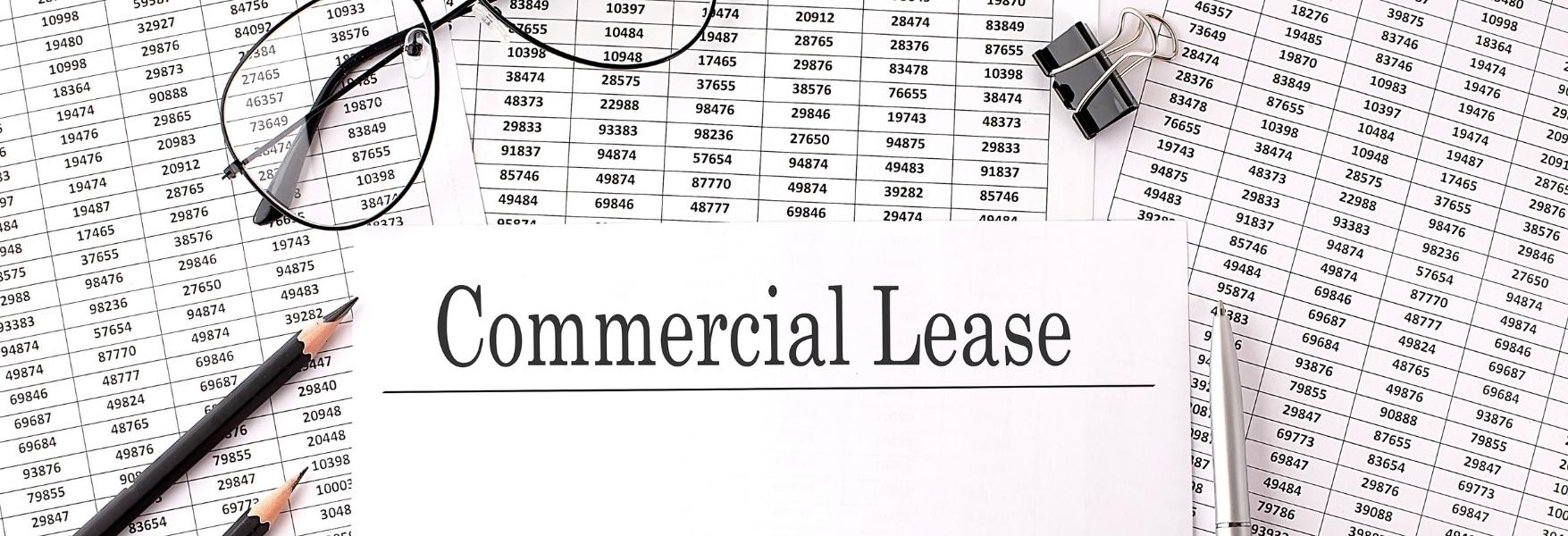Paper with Commercial Lease on a table with chart