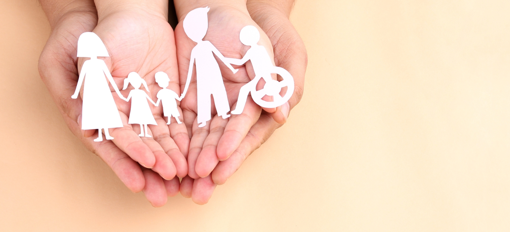 Hands holding paper cutout of different family members being together
