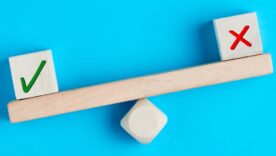 Tick mark outweighs cross mark on and imbalanced seesaw. Concept of positive evaluation in decision making, approval or voting.