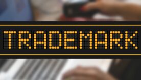 Orange color led banner in word trademark on black background.