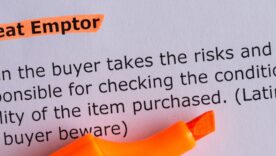 Caveat emptor word highlighted on the white paper