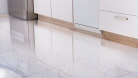 Close-up Photo Of Flooded Floor In Kitchen From Water Leak.