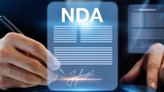 A business professional signs a digital Non-Disclosure Agreement (NDA) with a pen, emphasizing confidentiality and legal commitment.