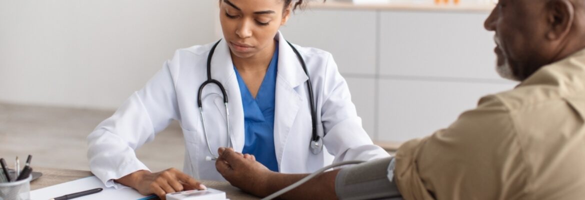 A healthcare professional in a white coat checks a patient's blood pressure in a modern clinic setting.