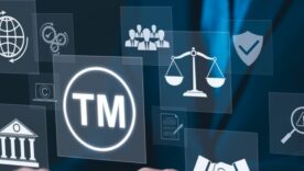 A business professional interacts with digital icons representing trademarks, legal concepts, and intellectual property.