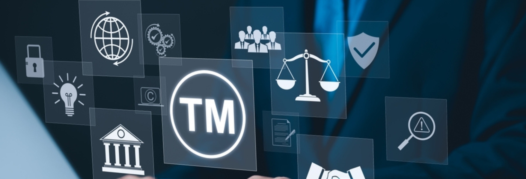 A business professional interacts with digital icons representing trademarks, legal concepts, and intellectual property.