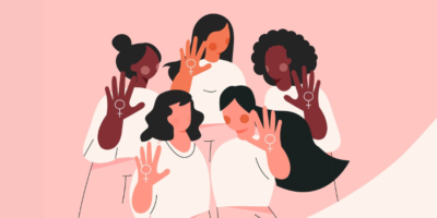 A diverse group of five women in white outfits hold up their hands, displaying symbols of femininity, against a pink background.