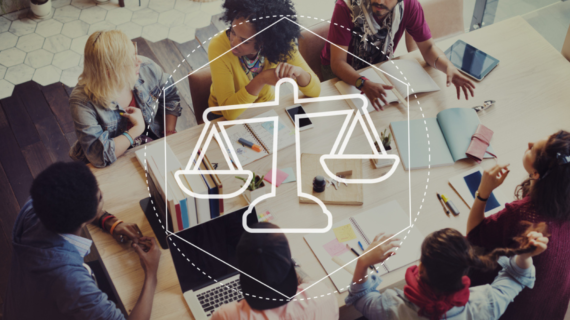 A diverse group of people collaborating around a table with notebooks, laptops, and a scales of justice icon overlay.