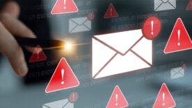 Hands in front of a keyboard with danger alert symbols in the foreground - concept of a cybersecurity warning for unsafe email communication